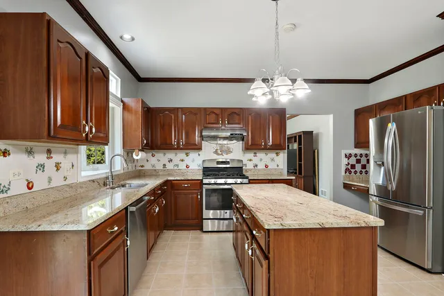 a kitchen with a sink stove and refrigerator
