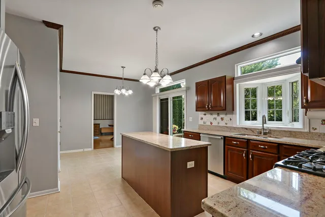 a kitchen with stainless steel appliances a sink stove and refrigerator