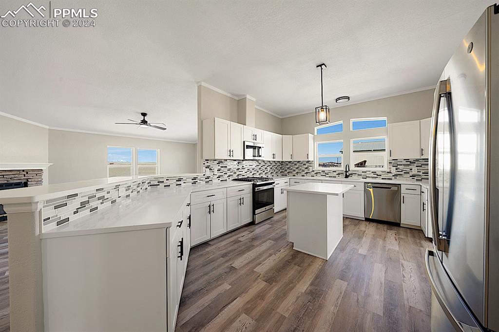 8160 Edison Road Yoder, CO 80864 - Photo 15 of 42 a kitchen with white cabinets sink and stainless steel appliances