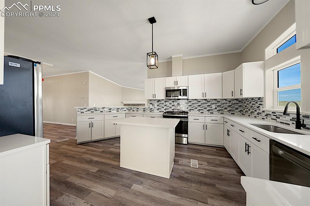 8160 Edison Road Yoder, CO 80864 - Photo 16 of 42 a kitchen with granite countertop white cabinets and white appliances