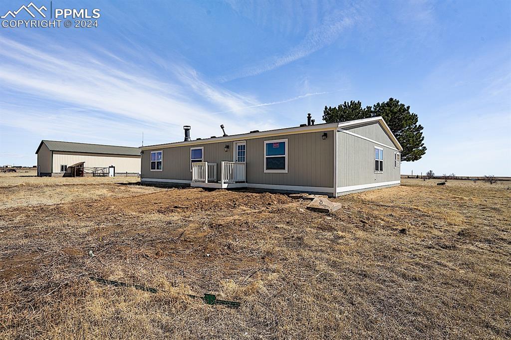 8160 Edison Road Yoder, CO 80864 - Photo 2 of 42 a front view of a house with a yard