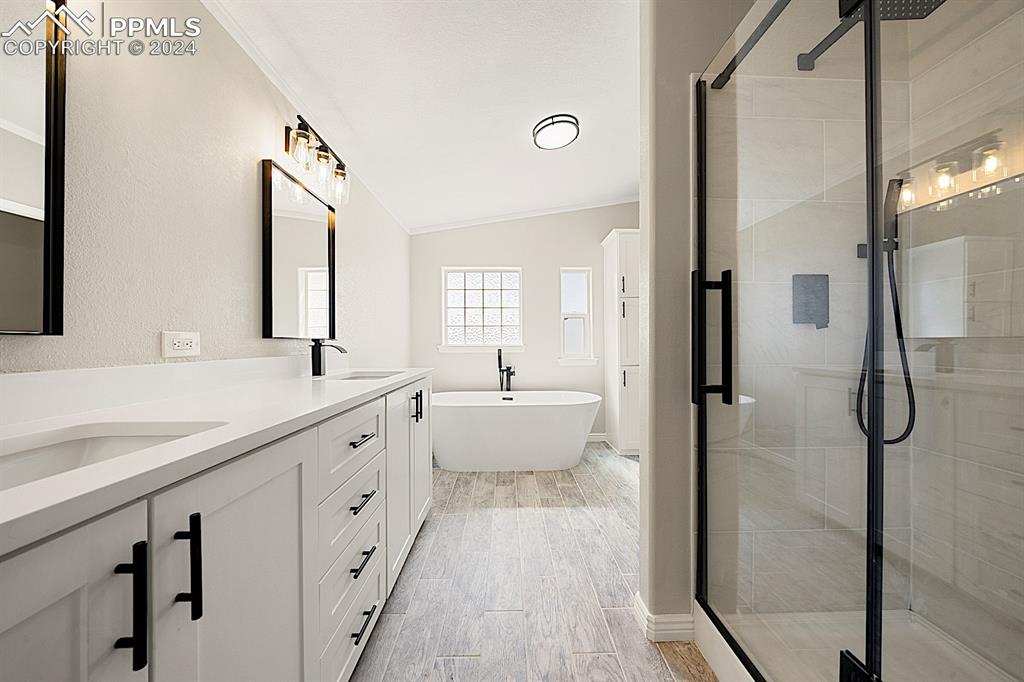 8160 Edison Road Yoder, CO 80864 - Photo 22 of 42 a spacious bathroom with a double vanity sink a mirror and shower