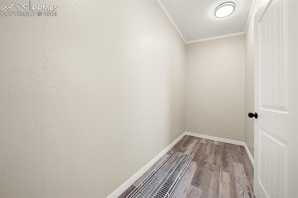 8160 Edison Road Yoder, CO 80864 - Photo 23 of 42 a view of a room with wooden floor and white walls