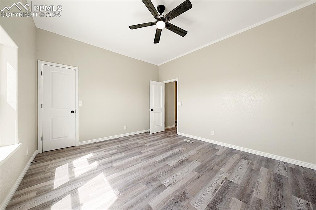 8160 Edison Road Yoder, CO 80864 - Photo 27 of 42 a view of a room with wooden floor and a ceiling fan