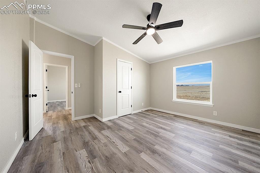 8160 Edison Road Yoder, CO 80864 - Photo 29 of 42 a view of empty room with wooden floor and window