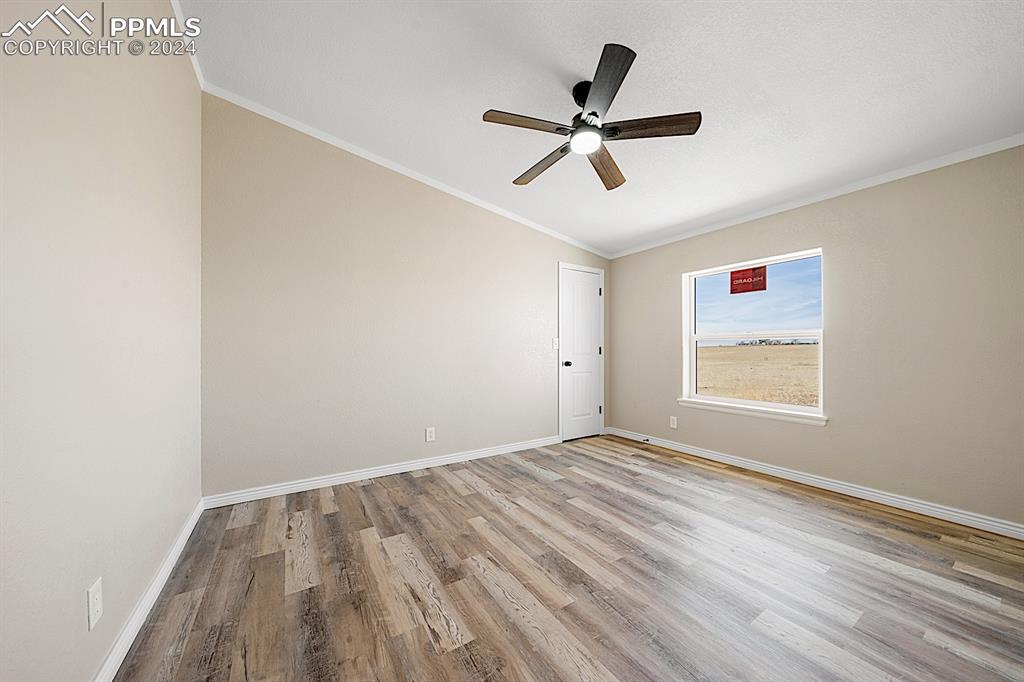 8160 Edison Road Yoder, CO 80864 - Photo 30 of 42 a view of empty room with wooden floor and fan