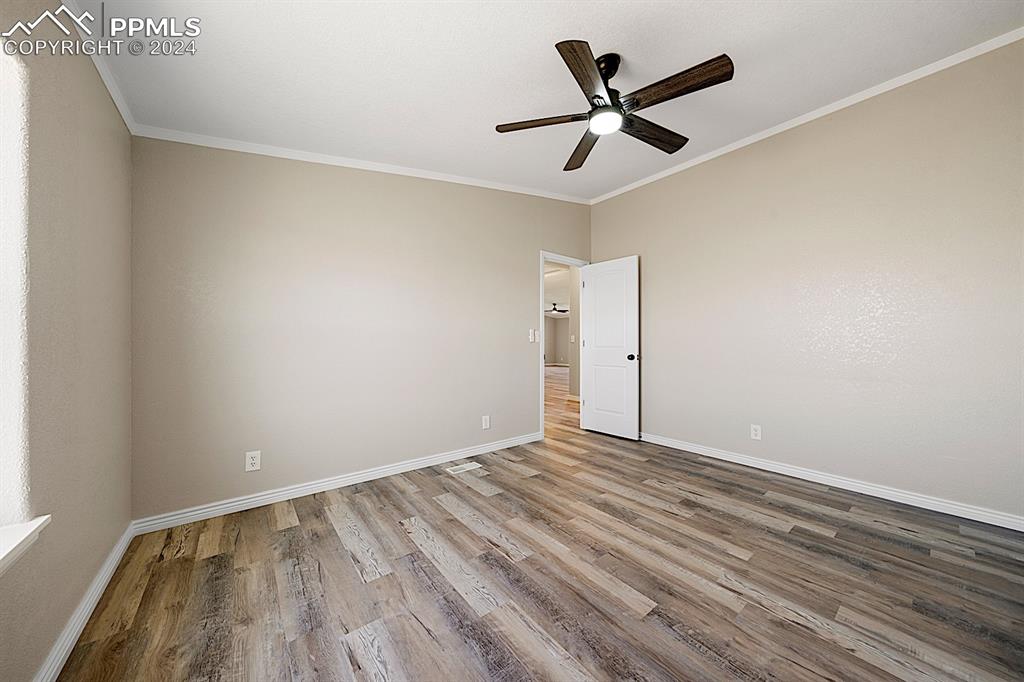 8160 Edison Road Yoder, CO 80864 - Photo 31 of 42 an empty room with wooden floor and ceiling fan