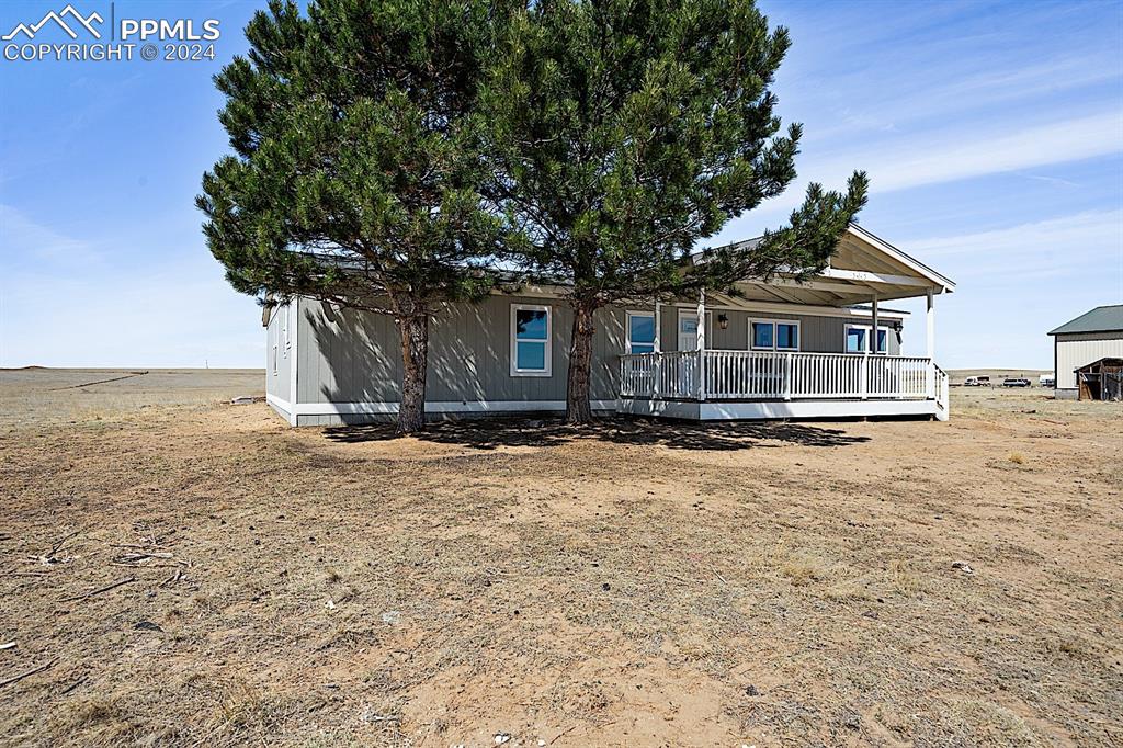 8160 Edison Road Yoder, CO 80864 - Photo 38 of 42 a front view of a house with a yard