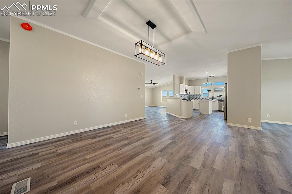 8160 Edison Road Yoder, CO 80864 - Photo 10 of 42 a view of a kitchen with a dishwasher and wooden floor