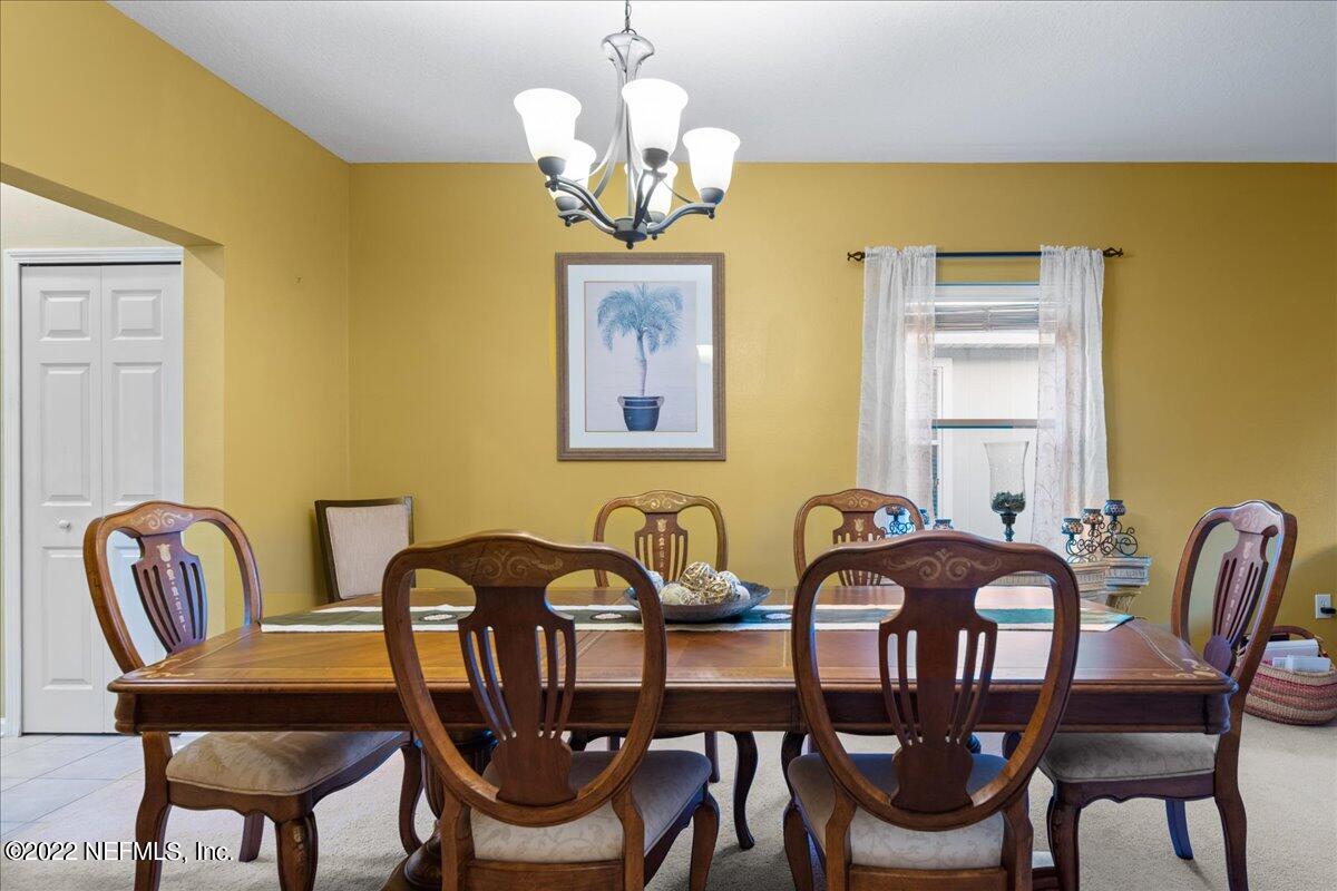 812 Crystal Spring Way St. Augustine, FL 32092 - Photo 9 of 30 a view of a dining room with furniture and chandelier