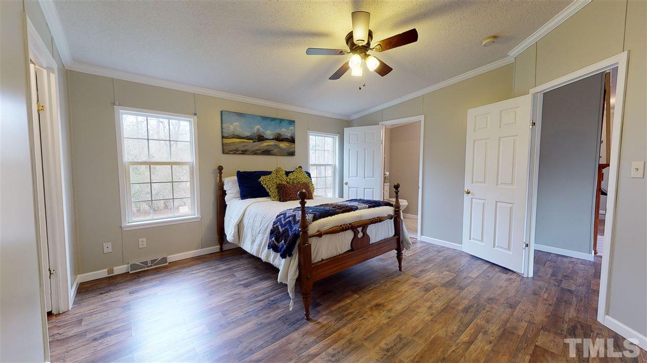 6603 Russell Road Durham, NC 27712 - Photo 8 of 30 Master Suite features spacious WIC & en-suite bathroom w/ dual vanity & walk-in-shower.