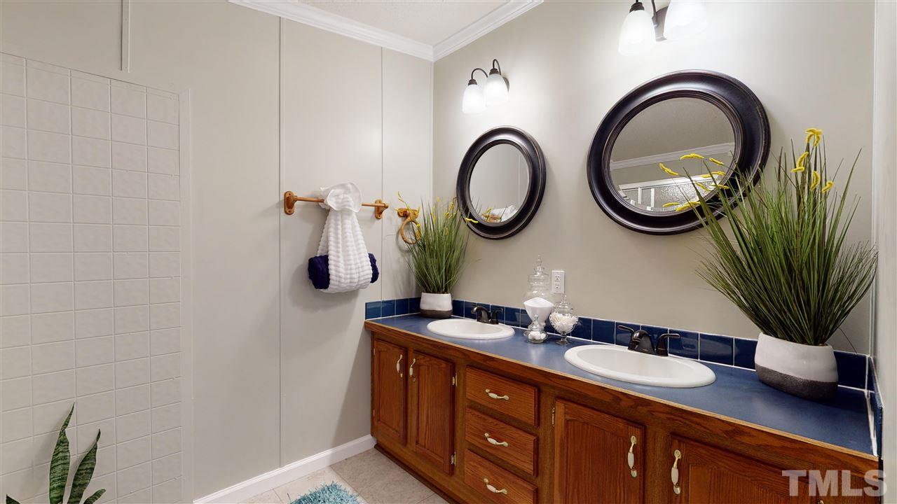 6603 Russell Road Durham, NC 27712 - Photo 10 of 30 Master Suite features spacious WIC & en-suite bathroom w/ dual vanity & walk-in-shower.
