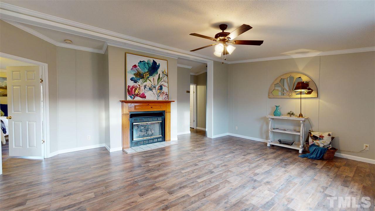 6603 Russell Road Durham, NC 27712 - Photo 28 of 30 Open floor-plan w/ over-sized family room featuring gas log fireplace & cathedral ceilings.