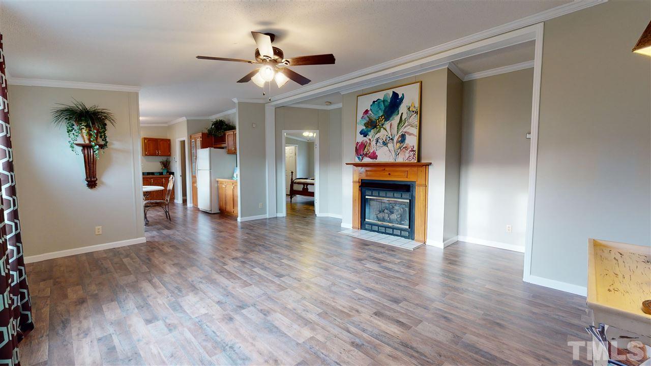 6603 Russell Road Durham, NC 27712 - Photo 29 of 30 Open floor-plan w/ over-sized family room featuring gas log fireplace & cathedral ceilings.