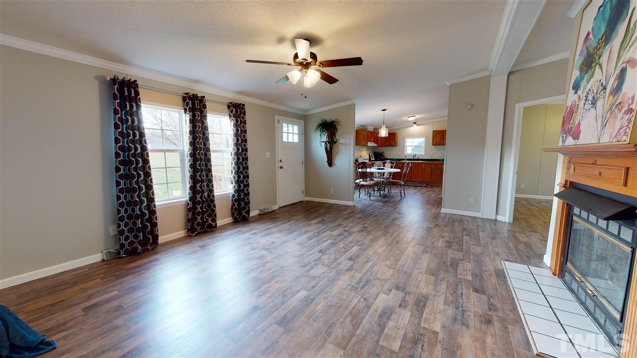 6603 Russell Road Durham, NC 27712 - Photo 30 of 30 Open floor-plan w/ over-sized family room featuring gas log fireplace & cathedral ceilings.
