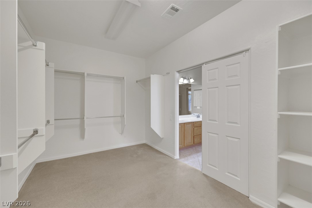 2501 Bechamel Place Henderson, NV 89044 - Photo 42 of 50 Ample built-in shelving and hanging space defines this generously sized walk-in wardrobe.