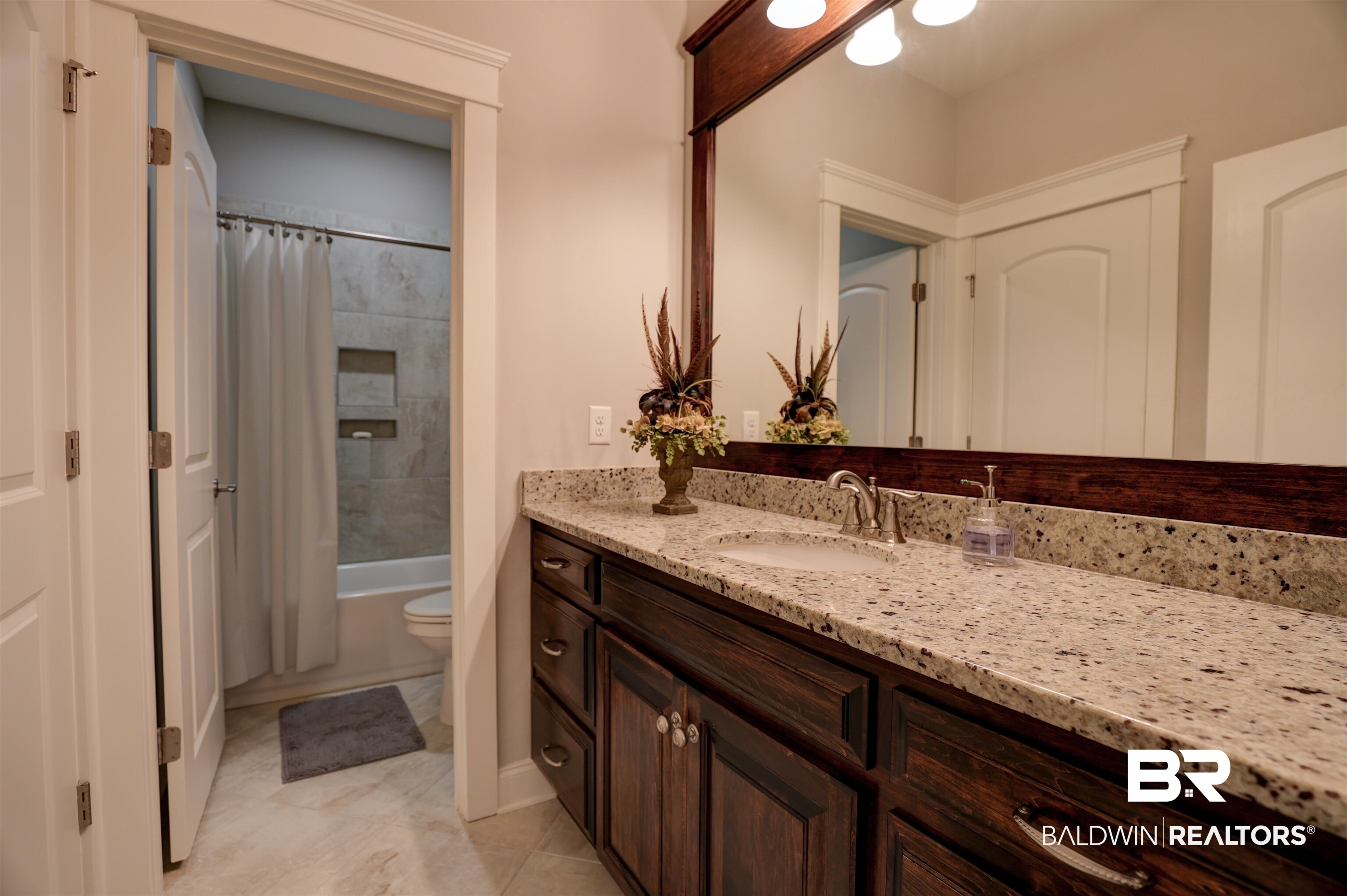 10588 Leesburg Pike Daphne, AL 36526 - Photo 18 of 29 Full bathroom with vanity, shower / bath combo, toilet, and tile patterned floors