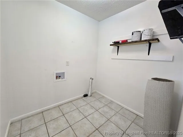 a view of storage and utility room with racks on the wall