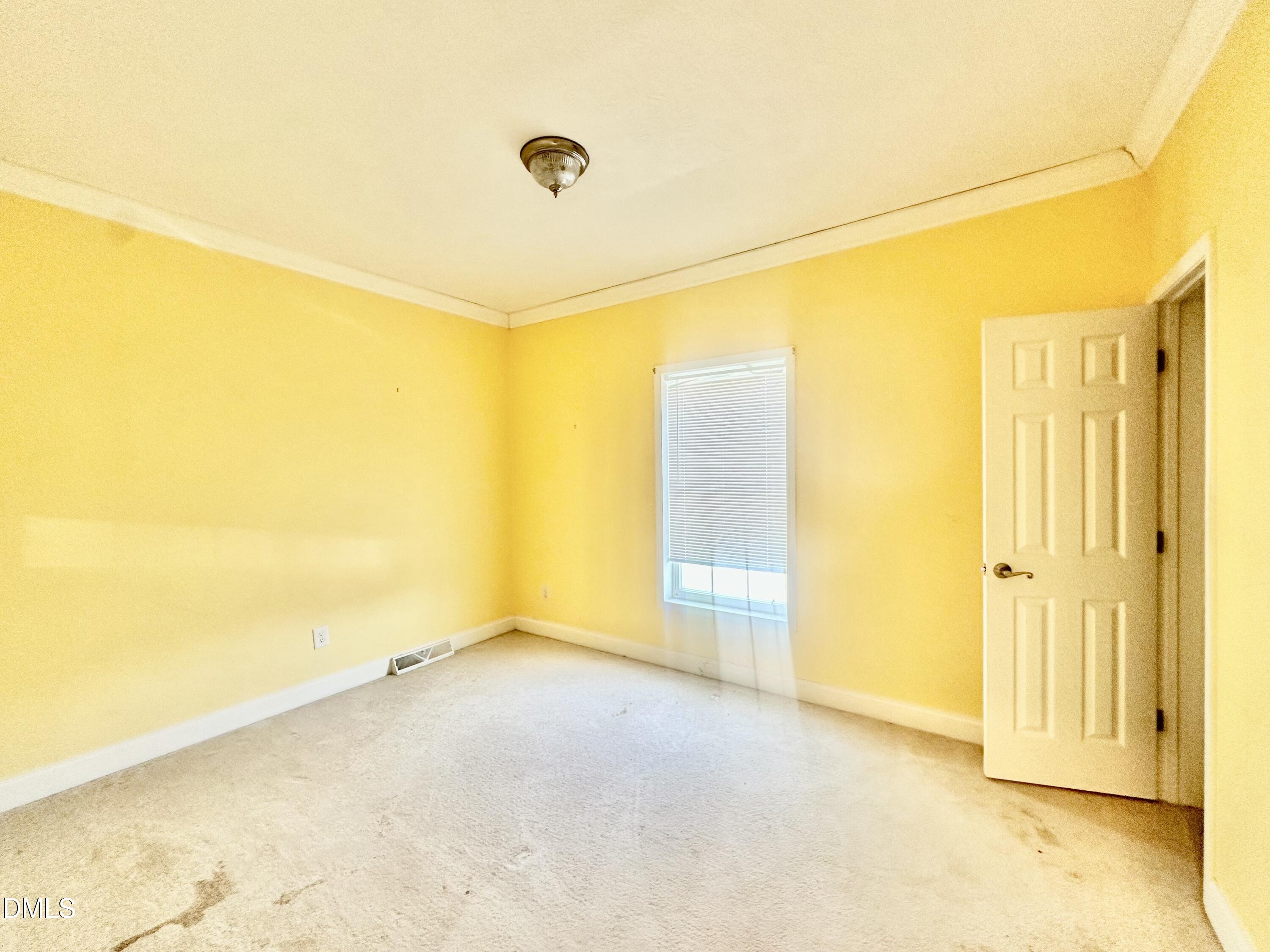 155 Collin Drive Roxboro, NC 27574 - Photo 13 of 20 an empty room with wooden floor and windows