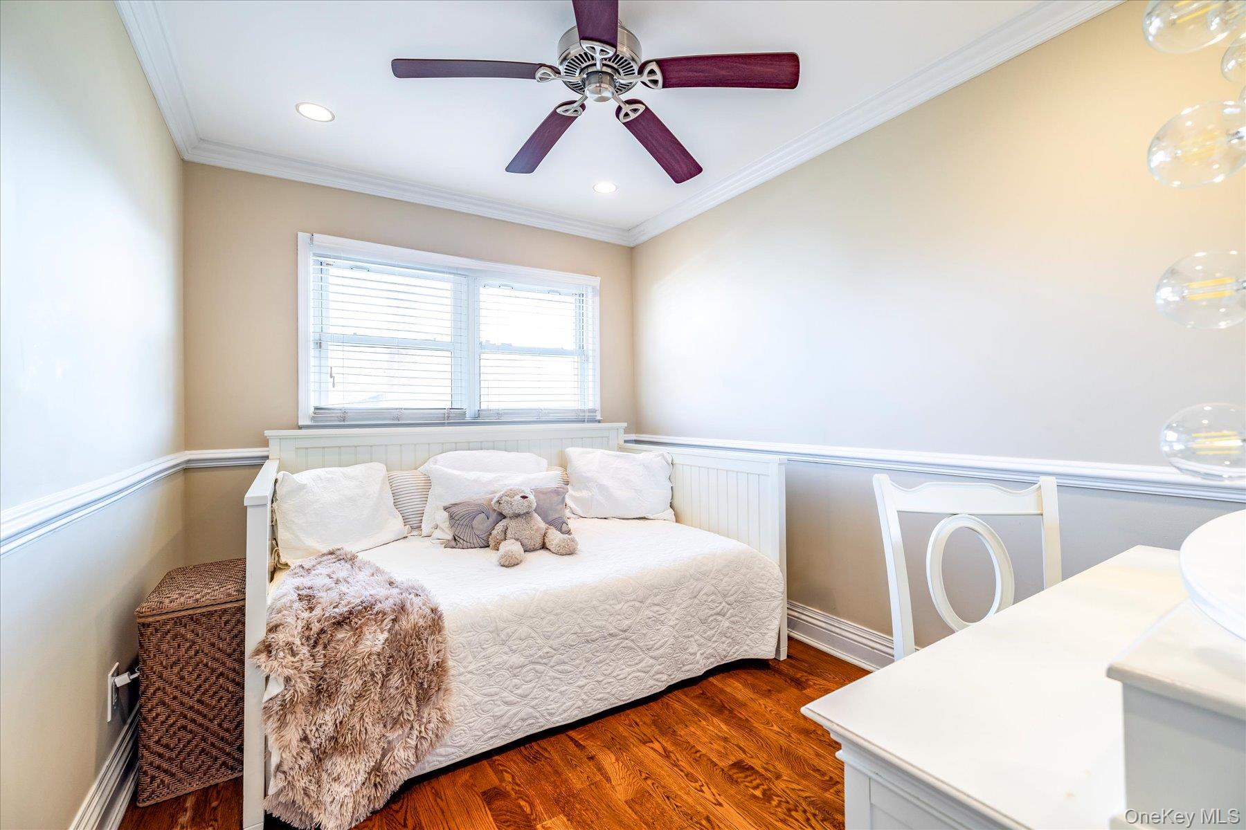 2863 Harbor Road Merrick, NY 11566 - Photo 16 of 35 a bedroom with a bed and a chandelier