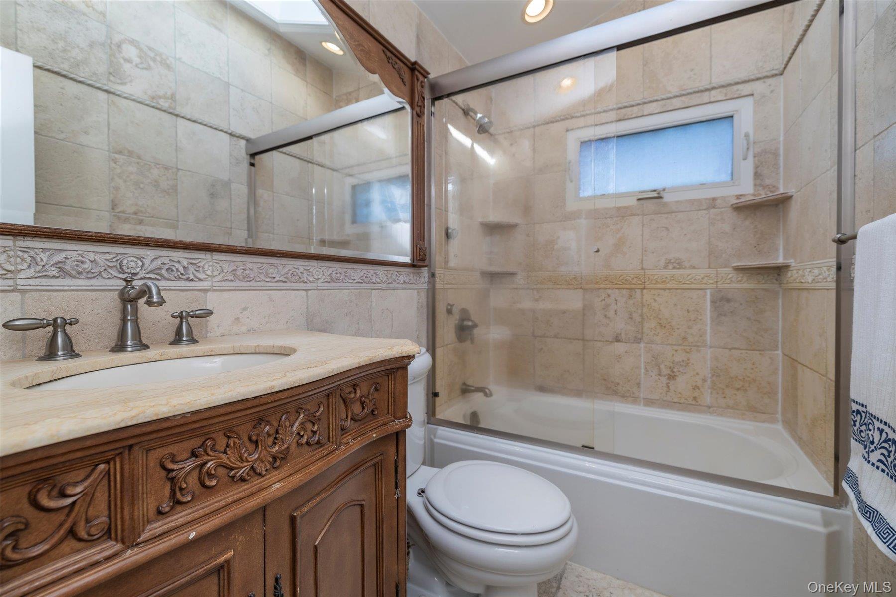 2863 Harbor Road Merrick, NY 11566 - Photo 17 of 35 a bathroom with a sink a toilet and shower