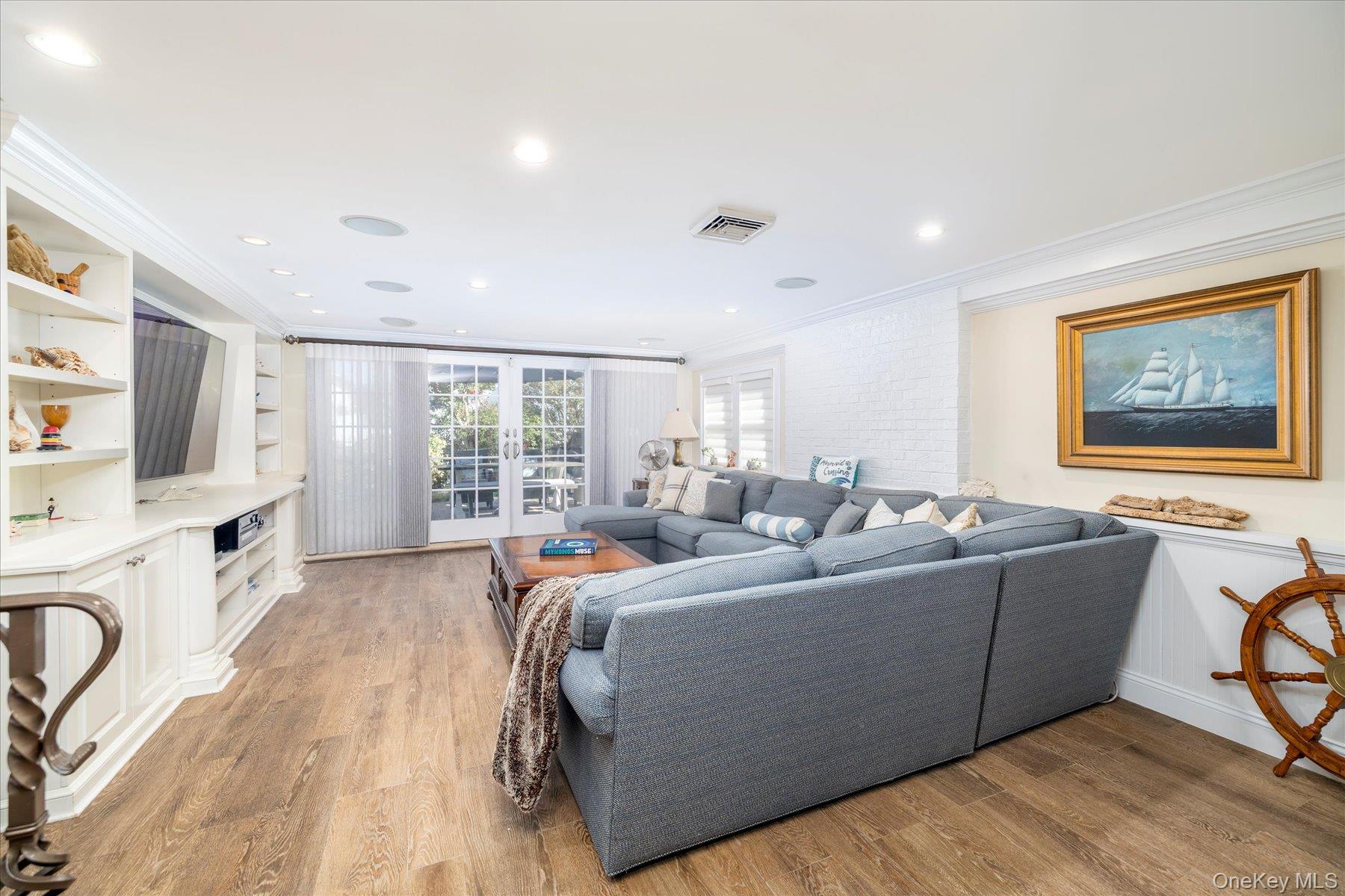2863 Harbor Road Merrick, NY 11566 - Photo 19 of 35 a living room with furniture and a flat screen tv