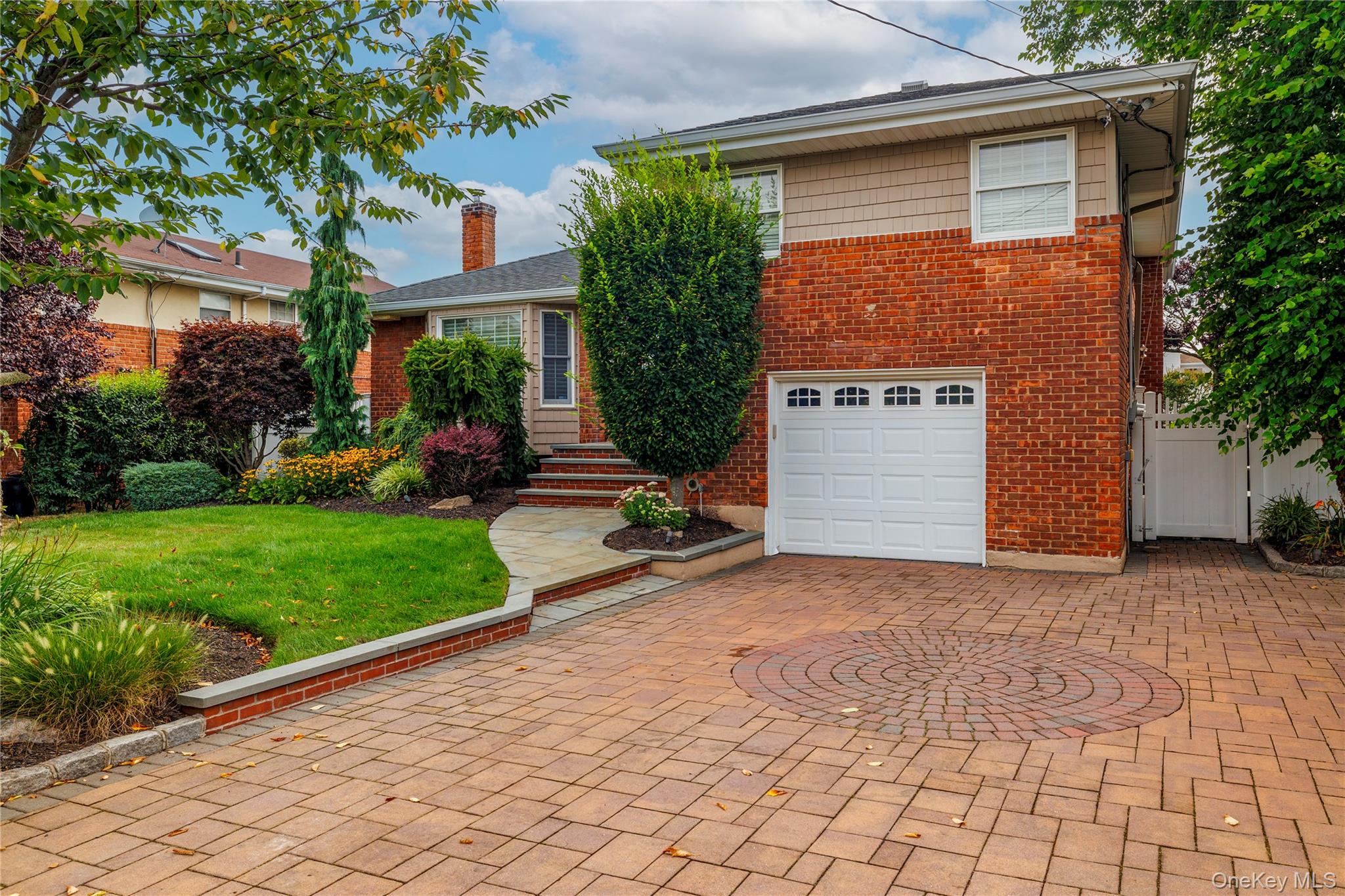 2863 Harbor Road Merrick, NY 11566 - Photo 2 of 35 a view of a backyard with plants and brick wall