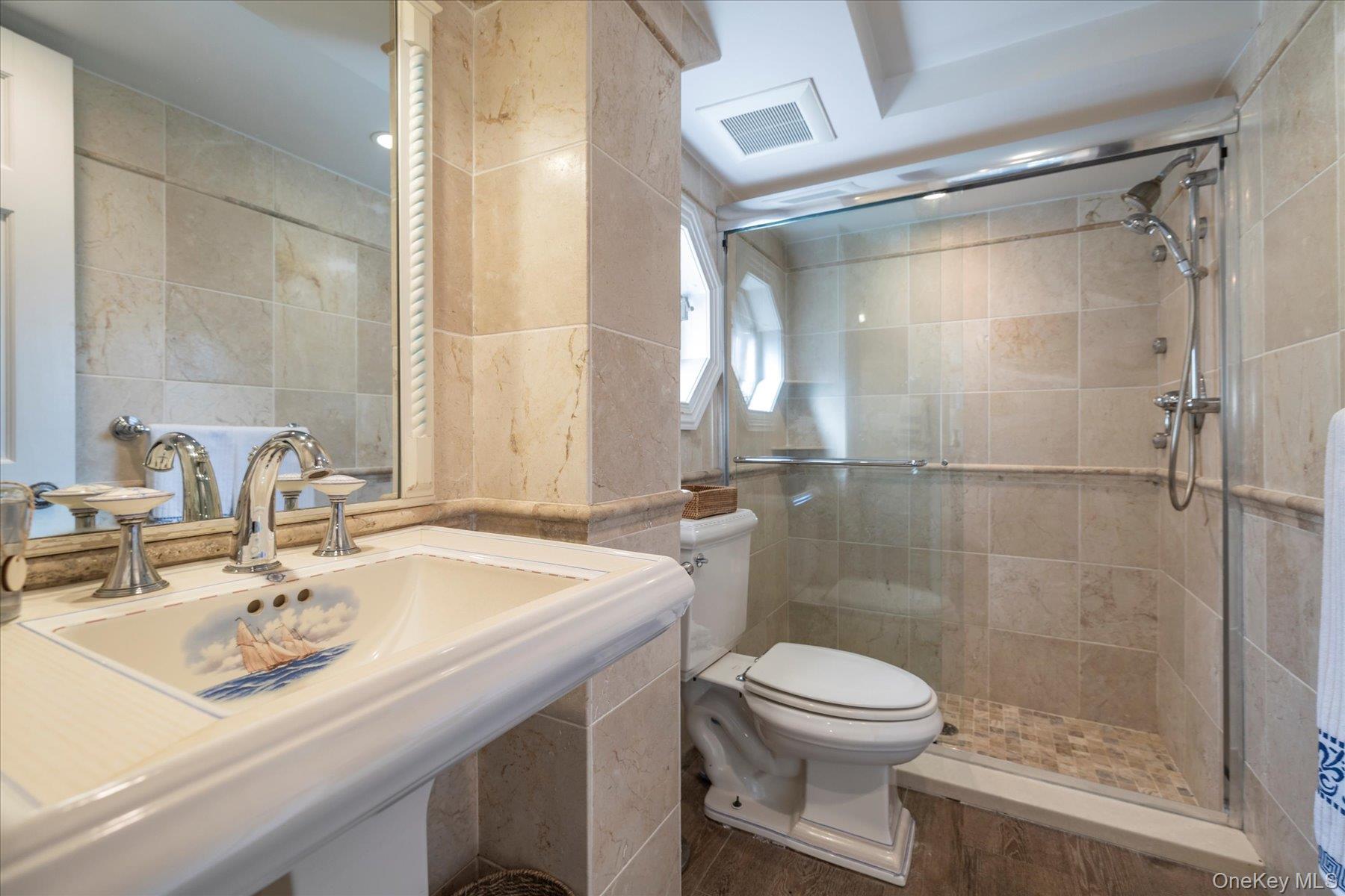 2863 Harbor Road Merrick, NY 11566 - Photo 21 of 35 a bathroom with a sink toilet a mirror and shower