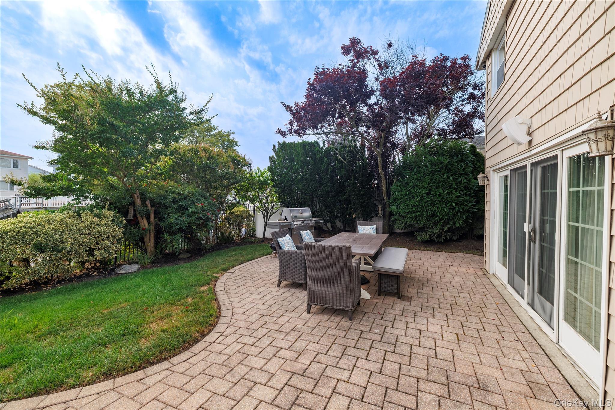 2863 Harbor Road Merrick, NY 11566 - Photo 26 of 35 a view of a patio with table and chairs and potted plants