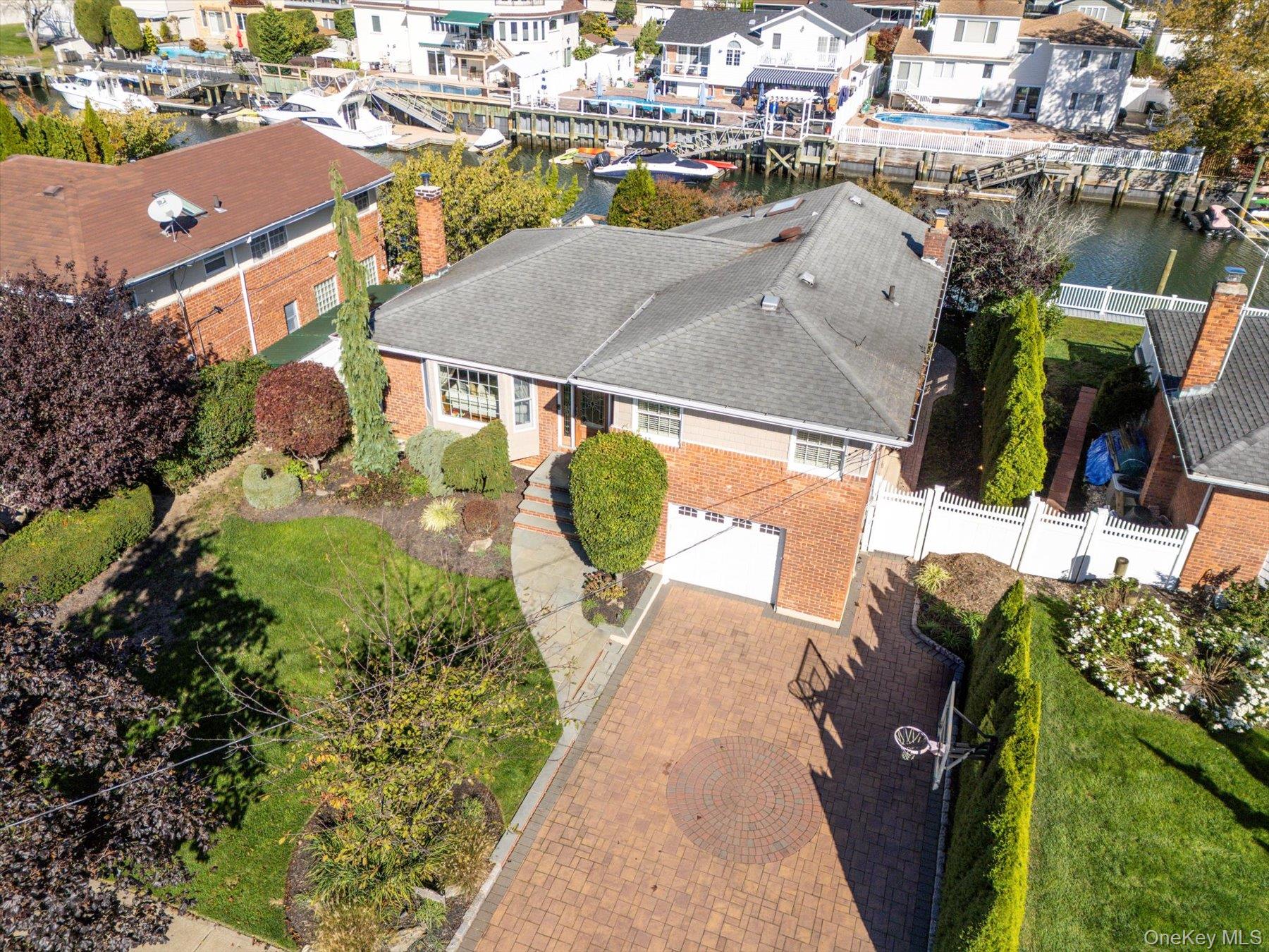2863 Harbor Road Merrick, NY 11566 - Photo 32 of 35 an aerial view of a house with a yard and lake view