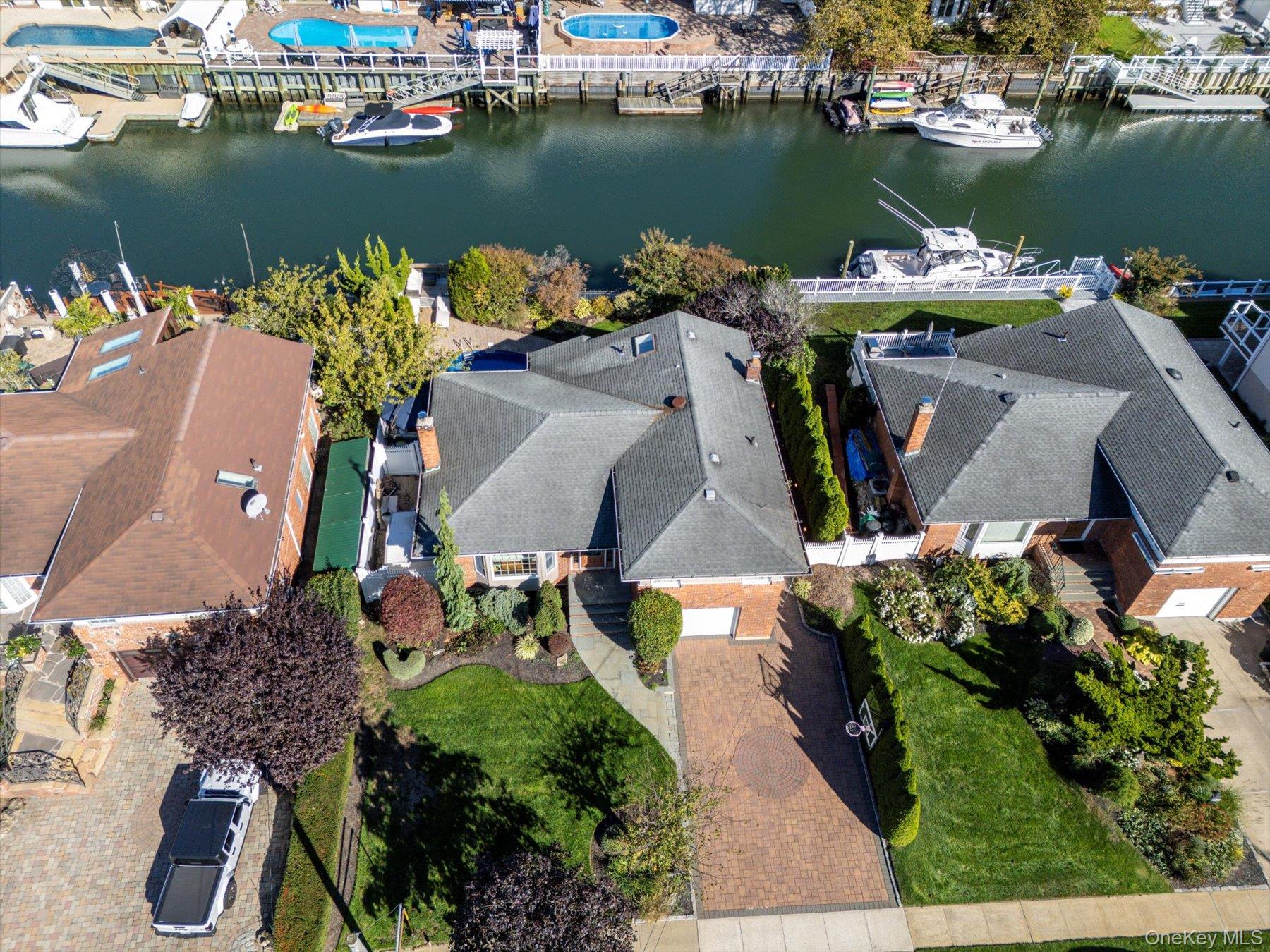 2863 Harbor Road Merrick, NY 11566 - Photo 33 of 35 an aerial view of a house with a table chairs and a swimming pool