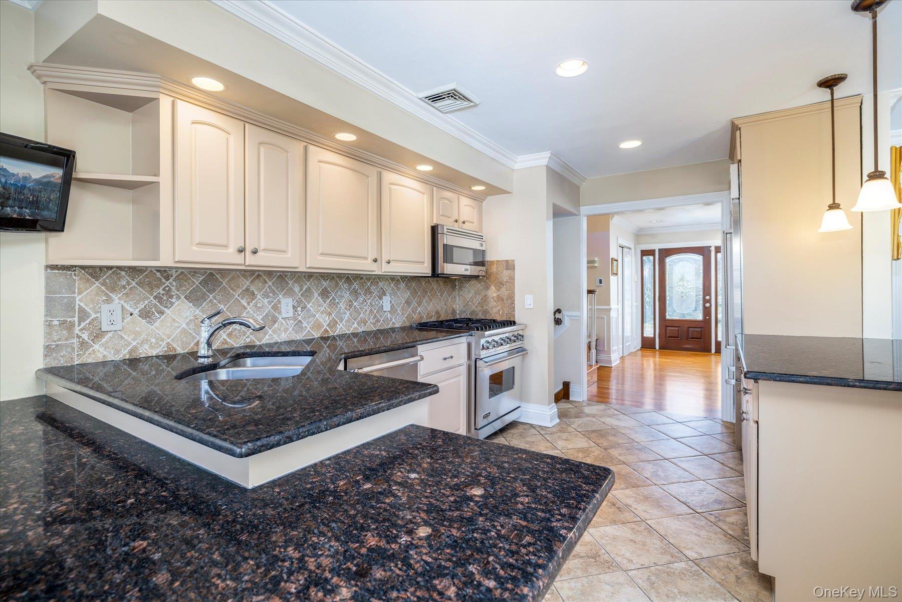 2863 Harbor Road Merrick, NY 11566 - Photo 6 of 35 a kitchen with stainless steel appliances granite countertop a sink stove and cabinets