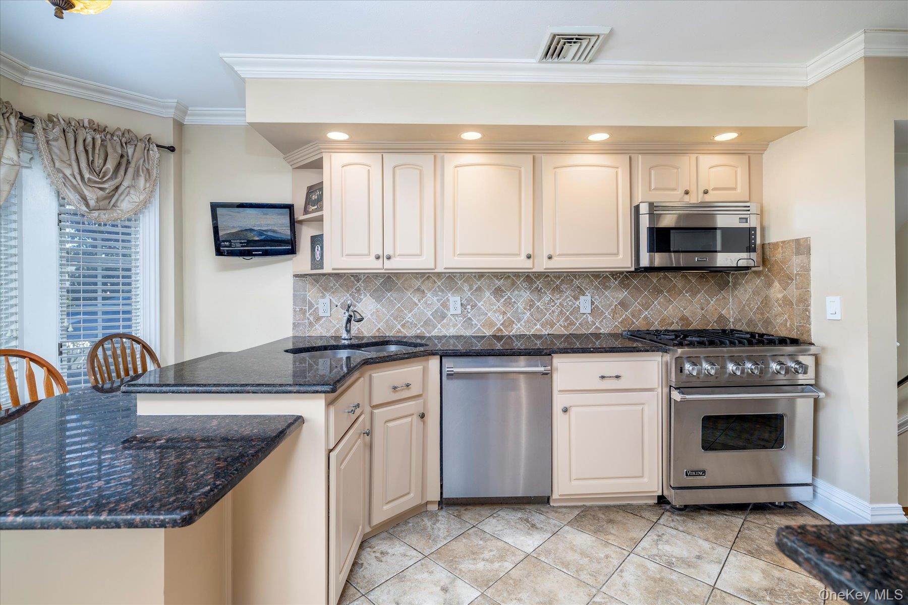2863 Harbor Road Merrick, NY 11566 - Photo 8 of 35 a kitchen with stainless steel appliances granite countertop a stove sink and cabinets