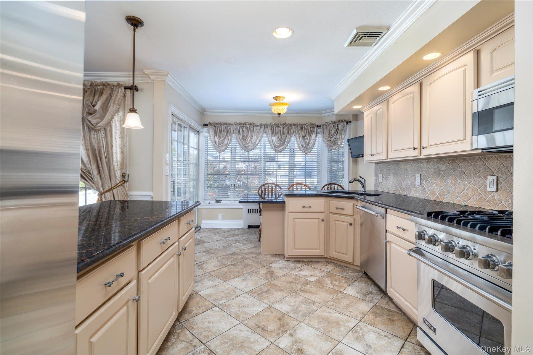 2863 Harbor Road Merrick, NY 11566 - Photo 9 of 35 a kitchen with granite countertop a sink stainless steel appliances and cabinets