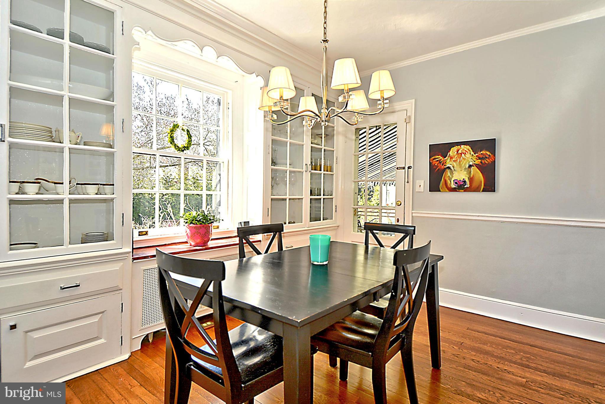 103 Tunbridge Road Baltimore, MD 21212 - Photo 14 of 30 a view of a dining room with furniture a chandelier and wooden floor