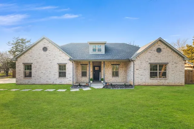 a front view of house with yard and green space