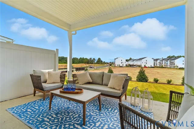 a roof deck with couches and city view