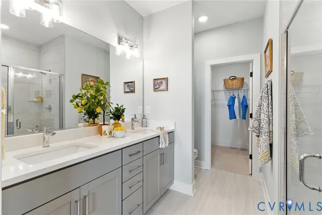 a bathroom with a double vanity sink mirror and shower