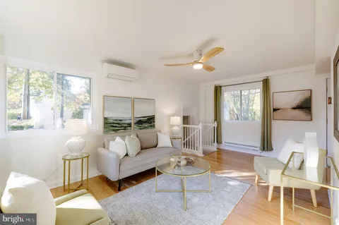 a living room with furniture a rug and a large window