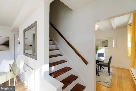 a view of a hallway with furniture and staircase
