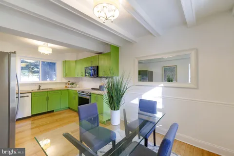 a living room with furniture and a kitchen