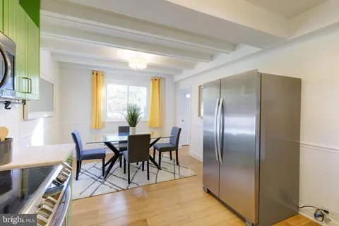 a dining room with furniture and wooden floor