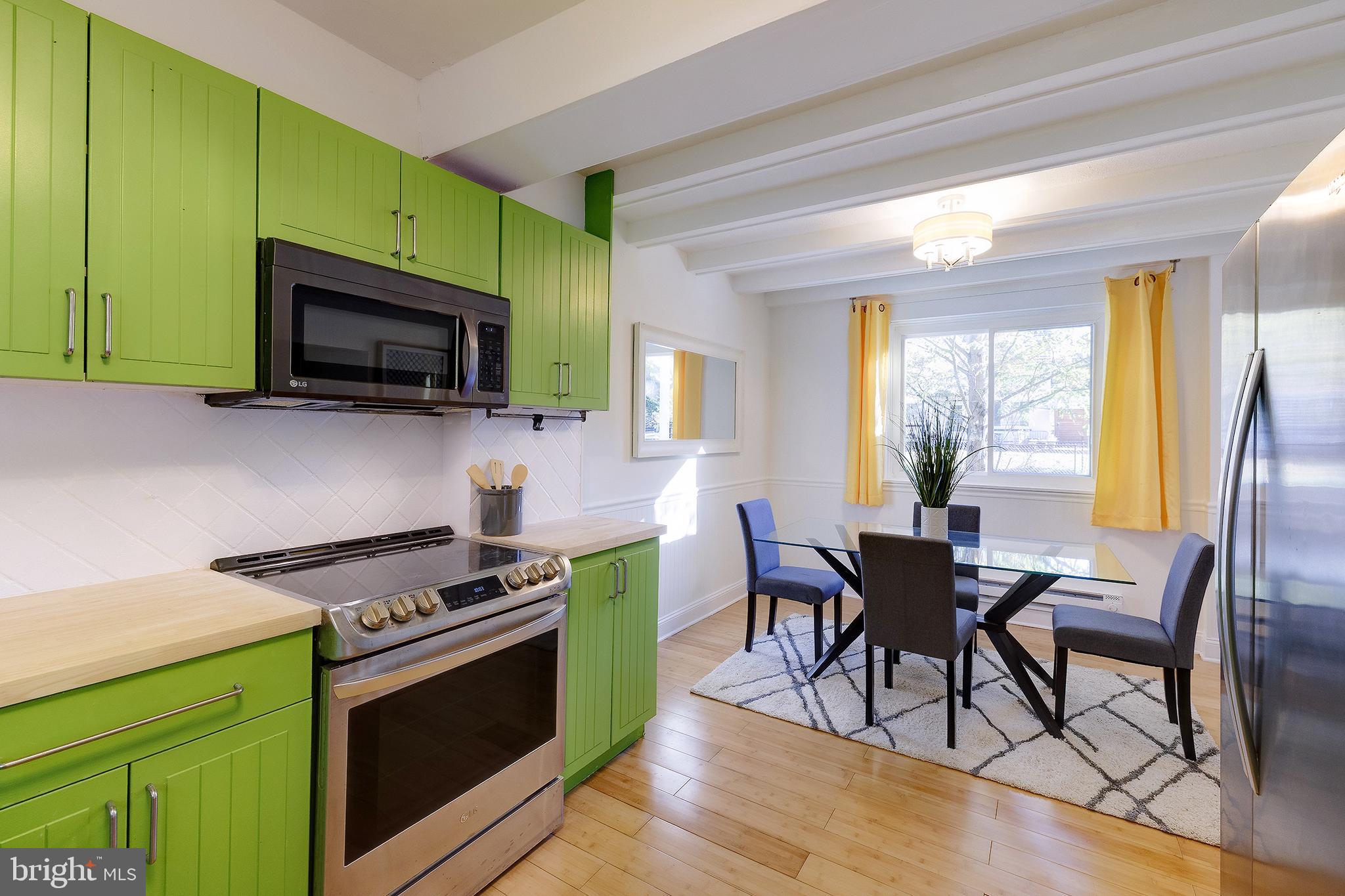 10 Hillside Road Greenbelt, MD 20770 - Photo 22 of 50 a kitchen with stainless steel appliances a stove a sink and a microwave