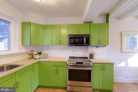 a kitchen with a sink cabinets and stainless steel appliances