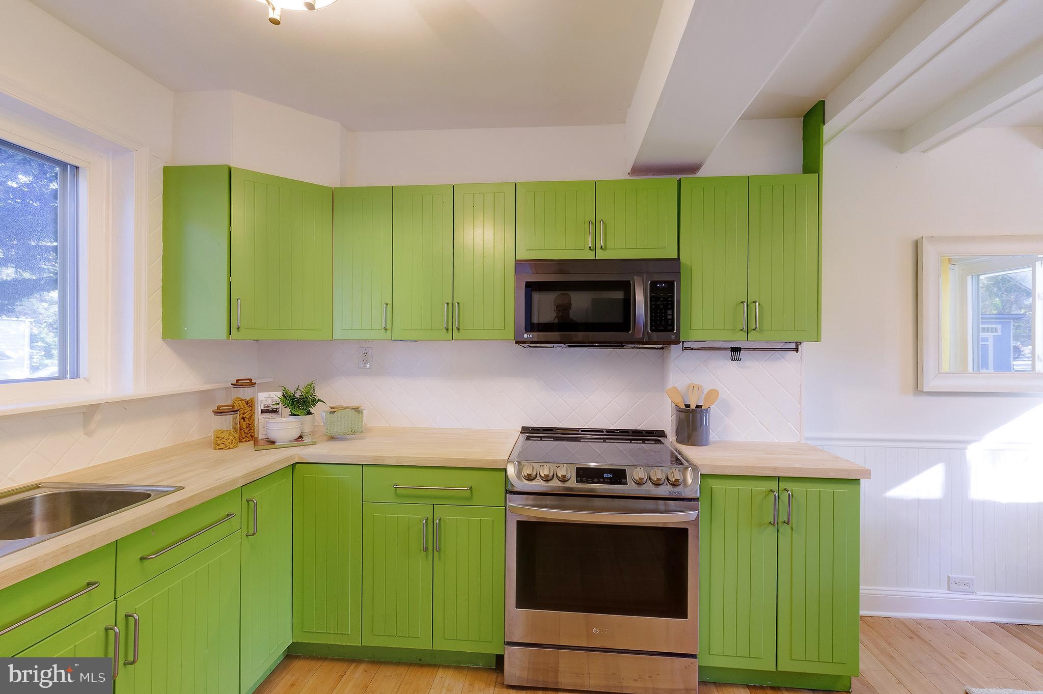 10 Hillside Road Greenbelt, MD 20770 - Photo 23 of 50 a kitchen with a sink cabinets and stainless steel appliances