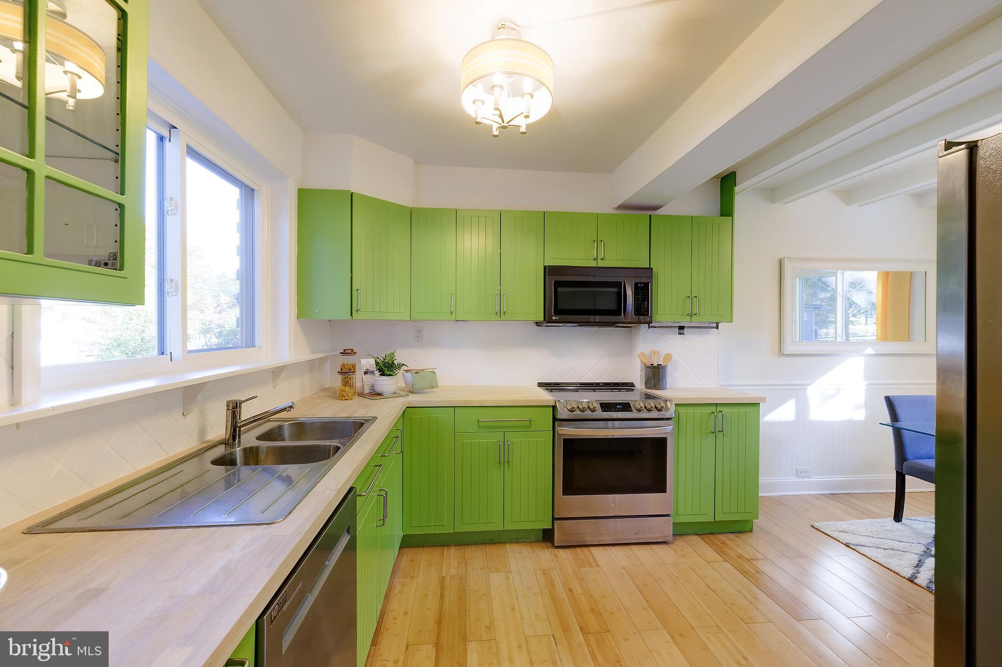 10 Hillside Road Greenbelt, MD 20770 - Photo 25 of 50 a kitchen with a sink and a stove top oven
