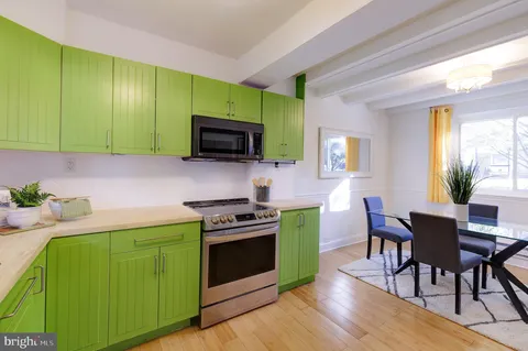 a kitchen with a sink cabinets and wooden floors