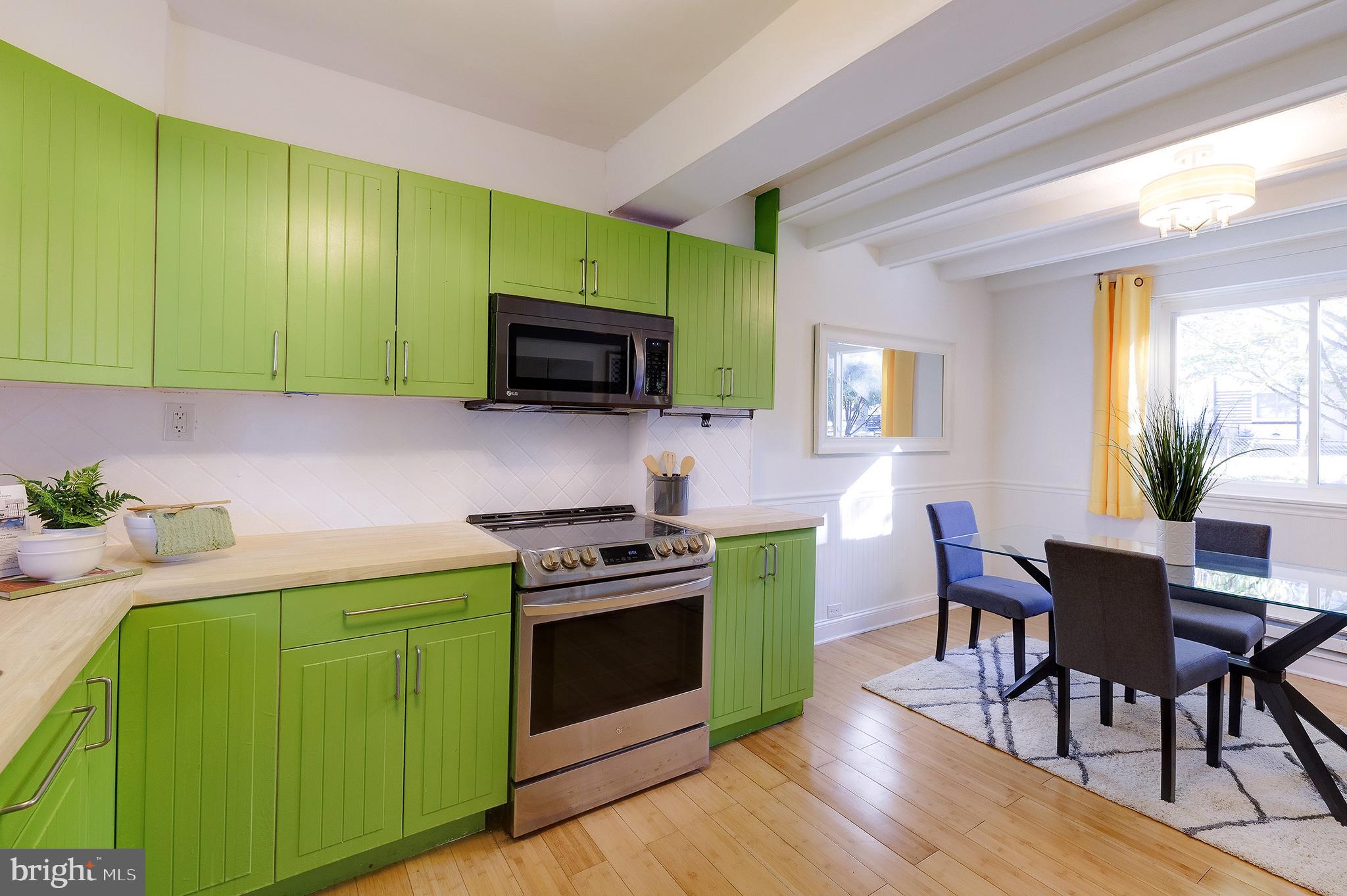10 Hillside Road Greenbelt, MD 20770 - Photo 26 of 50 a kitchen with a sink cabinets and wooden floors