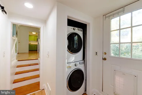 a view of a hallway with washer and dryer