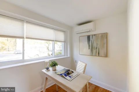 a bedroom with a bed and a potted plant